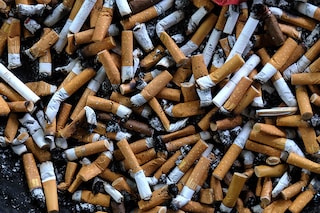 An ashtray filled with cigarettes butts is seen on an outdoor smoking stand at a busstop in Bremerhaven, northern Germany. (Credits: PATRIK STOLLARZ / AFP)