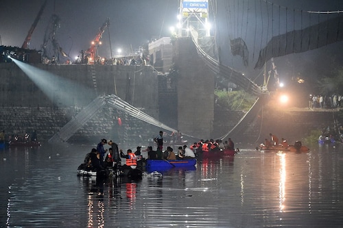 Rescue personnel continue their search operations on the third day after a colonial-era pedestrian bridge across the river Machchhu collapsed in Morbi, Gujarat early on October 31, 2022. At least 135 people are confirmed dead after the 150-year-old bridge collapsed, sending scores of people tumbling into the river below.