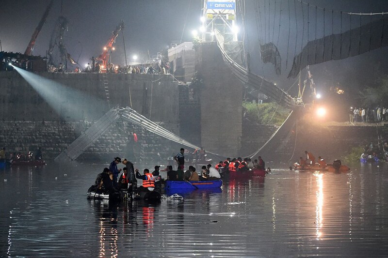 Rescue personnel continue their search operations on the third day after a colonial-era pedestrian bridge across the river Machchhu collapsed in Morbi, Gujarat early on October 31, 2022. At least 135 people are confirmed dead after the 150-year-old bridge collapsed, sending scores of people tumbling into the river below.