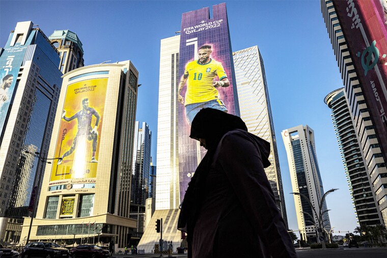 A silhouette of a woman walking in the street in Doha ahead of the kick-off of the FIFA World Cup 2022 in Qatar on November 20.