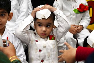 A boy dressed as India"s first prime minister Jawaharlal Nehru, gestures during a celebration of Children’s Day on the occasion of Nehru"s 133rd birth anniversary, at a school in Amritsar on November 14, 2022.