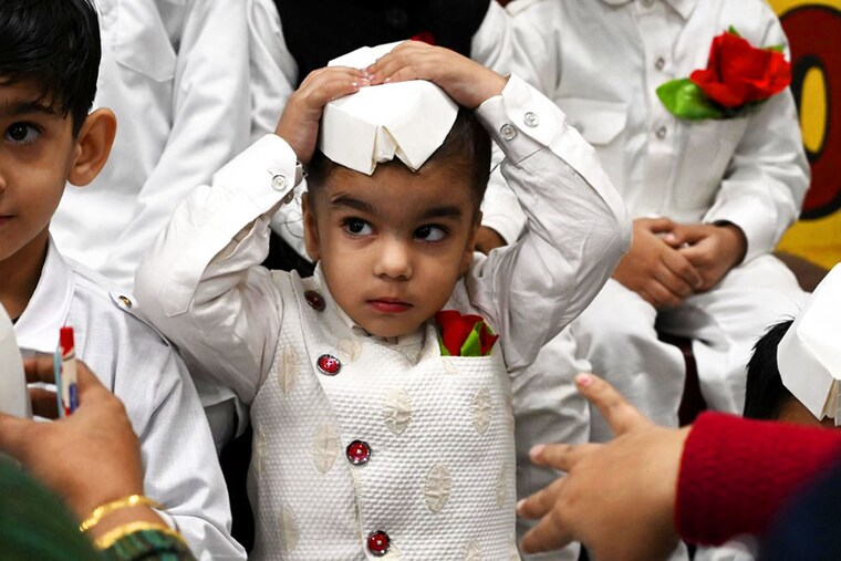 A boy dressed as India"s first prime minister Jawaharlal Nehru, gestures during a celebration of Children’s Day on the occasion of Nehru"s 133rd birth anniversary, at a school in Amritsar on November 14, 2022.