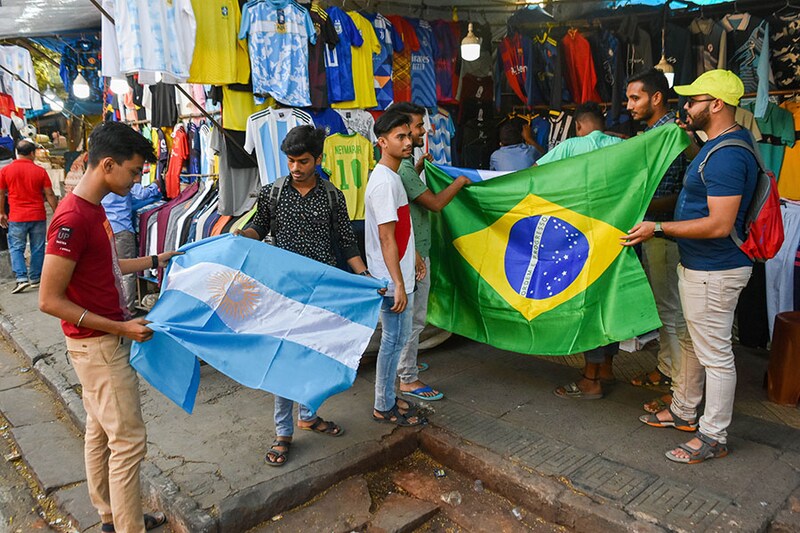 Fans throng stalls shopping for jerseys and flags of their favourite teams ahead of FIFA World Cup 2022 at the Esplanade market in Kolkata, India on 15 November 2022 . Thirty two nations will compete for the World Cup that kicks off in Qatar on 20th November.