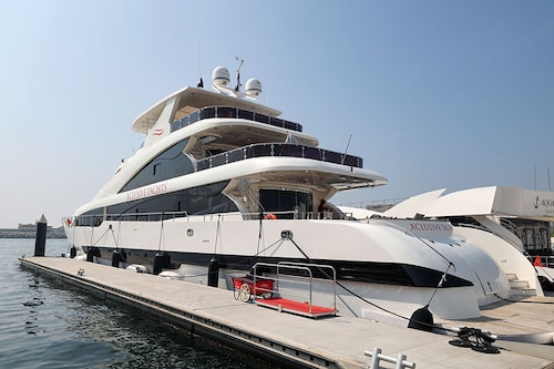 The boat, which can accommodate up to 125 people, is among a number of pristine white yachts at Dubai"s Marina Harbour