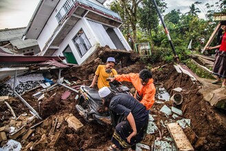 Villagers salvage items from damaged houses following a 5.6-magnitude earthquake that killed at least 252 people, with hundreds injured and others missing in Cianjur, a region in West Java, Indonesia on November 22, 2022.
