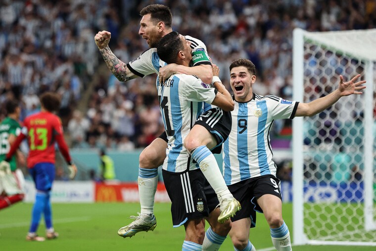 Lionel Messi of Argentina celebrates with his teammates Angel Di Maria and Julian Alvarez after scoring a stunning first goal in the FIFA World Cup Qatar 2022 Group C match between Argentina and Mexico at Lusail Stadium on November 26, 2022 in Lusail City, Qatar. Messi then came up with a crucial assist to set up Enzo Fernandez for Argentina’s second goal in the 87th minute, helping win the match.