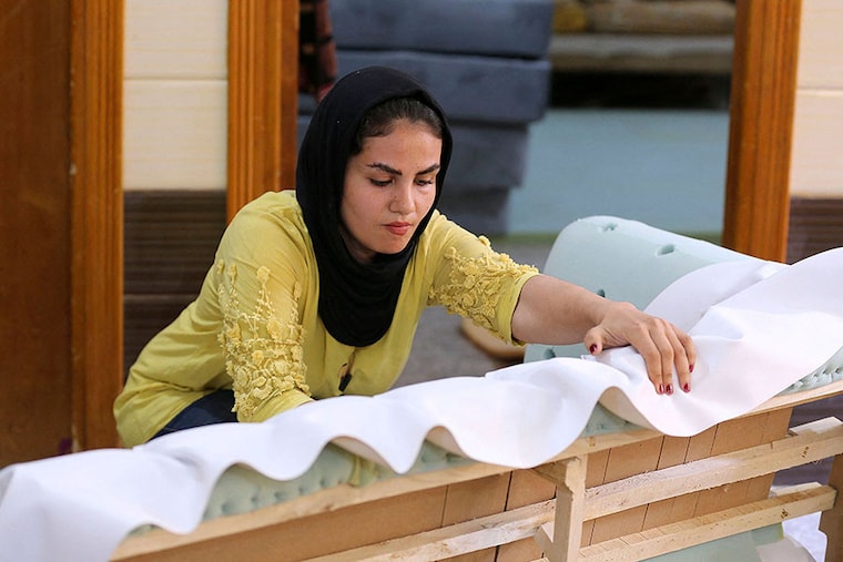 Iraqi carpenter Nour al-Janabi works at her home furniture workshop in Baghdad"s Abu Dsheer area. Image: Photography Sabah ARAR / AFP