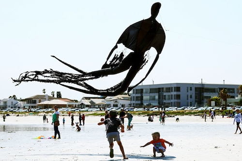 Children play with a kite depicting a dementor from the Harry Potter series during the 28th Cape Town International Kite Festival at Melkbosstrand, Cape Town, South Africa on October 9, 2022. It is an awareness campaign for World Mental Health Day where kite enthusiasts gather to fly colourful kites, participate in social activities, and raise funds for mental health support. Around the world, October 10 is being observed as "World Mental Health Day".