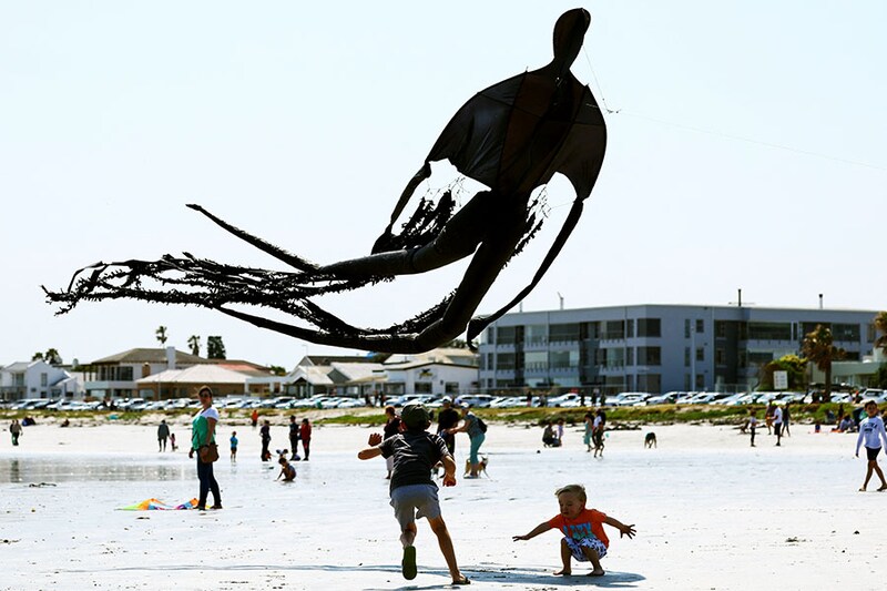 Children play with a kite depicting a dementor from the Harry Potter series during the 28th Cape Town International Kite Festival at Melkbosstrand, Cape Town, South Africa on October 9, 2022. It is an awareness campaign for World Mental Health Day where kite enthusiasts gather to fly colourful kites, participate in social activities, and raise funds for mental health support. Around the world, October 10 is being observed as "World Mental Health Day".