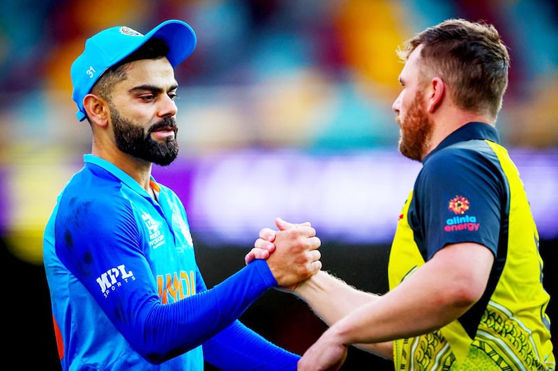 Australia"s captain Aaron Finch (R) shakes hands with India"s Virat Kohli after the ICC 2022 Twenty20 World Cup cricket warm-up match between Australia and India at the Gabba in Brisbane on October 17, 2022. India won the match by 6 runs.