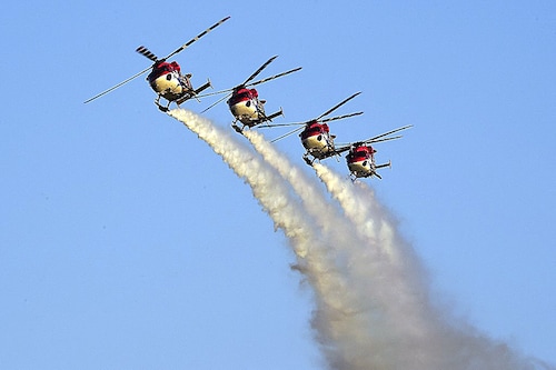 Indian Air Force (IAF) advanced light helicopters display team "Sarang" perform during an airshow at the Defence Expo 2022, in Ahmedabad on October 19, 2022.