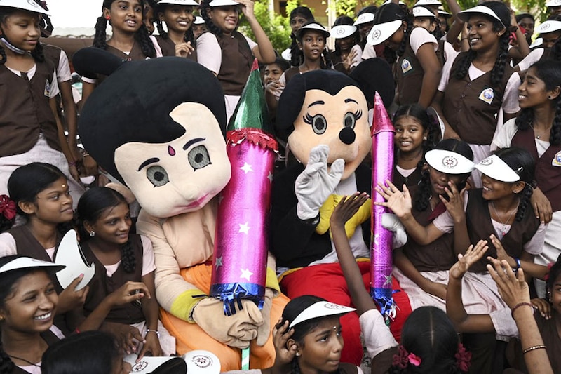 Firefighters dressed as cartoon characters participate in an awareness campaign against using firecrackers during the celebrations of Diwali, at a school in Chennai on October 20, 2022.