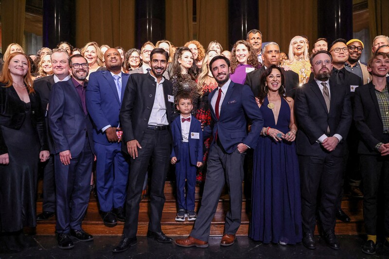 Indian photojournalists Adnan Abidi and Amit Dave flank six-year-old Yunus Siddiqui, son of the late Danish Siddiqui at the 2022 Pulitzer Prize event during a group photo. Late Danish Siddiqui was a part of Reuters" winning entry for Feature Photography in Manhattan, New York City, U.S., October 20, 2022. The winning team of Indian photojournalists includes Kashmir-based Sanna Irshad Mattoo who was denied permission by the Indian authorities to attend the event.