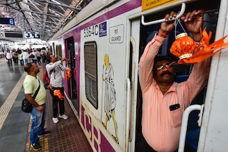 Motormen of Central Railway tie miniature sky lanterns to a local train"s cabin in celebration of Diwali festival at Chhatrapati Shivaji Maharaj Terminus on October 22, 2022 in Mumbai, India. Many motormen answer the call of duty, forgoing time at home with their families on festive days, plying trains to carry the rush of passengers in this season.