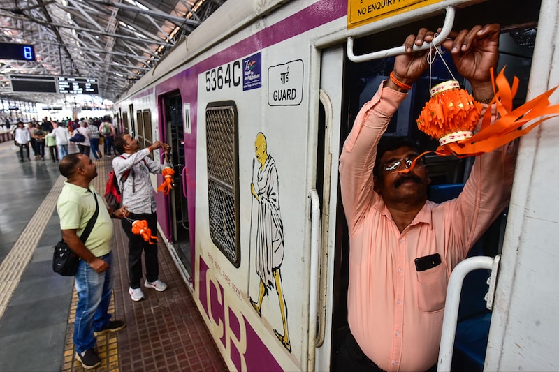 Motormen of Central Railway tie miniature sky lanterns to a local train"s cabin in celebration of Diwali festival at Chhatrapati Shivaji Maharaj Terminus on October 22, 2022 in Mumbai, India. Many motormen answer the call of duty, forgoing time at home with their families on festive days, plying trains to carry the rush of passengers in this season.