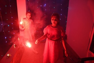 Children light sparklers during the Diwali festival in Nagaon District of Assam, India on October 24, 2022. Celebrations were low-key in the state as rains lashed many parts of Assam upon the impact of Cyclone Sitrang since Monday morning.