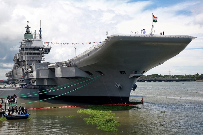 Indian Navy officers stand on the flight deck of India"s first home-built aircraft carrier INS Vikrant after its commissioning ceremony at a state-run shipyard in Kochi, India, September 2, 2022.