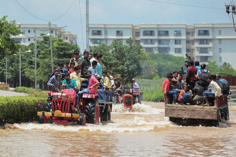 Tractors came to the rescue of commuters and residents in upscale housing through waterlogged streets after torrential rains paralysed Bengaluru on September 6, 2022. Shoddy infrastructure crippled the world-renowned IT hub for the last three days, with upscale areas left without electricity or drinking water. The city is bracing for more rainfall over the next days.