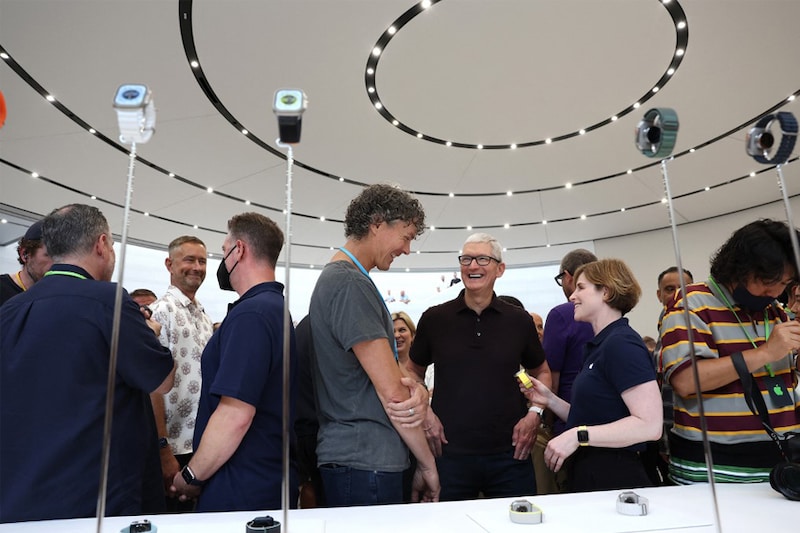 Apple CEO Tim Cook (C) looks at the new Apple Watch during an Apple special event on September 07, 2022, in Cupertino, California. Apple unveiled the new iPhone 14 as well as new versions of the Apple Watch, including the Apple Watch SE, a low-cost version of the popular timepiece that will start at $249.