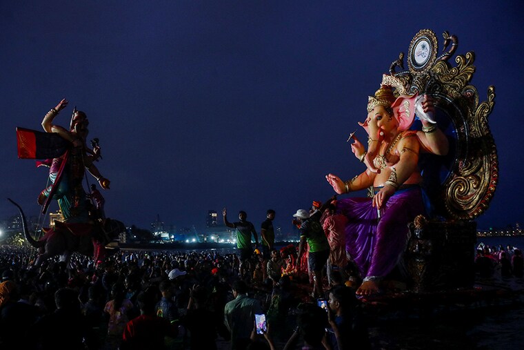 People carry an idol of Lord Ganesh, the deity of prosperity, for immersion into the Arabian Sea on the last day of the Ganesh Chaturthi Festival in Mumbai, India, September 9, 2022.