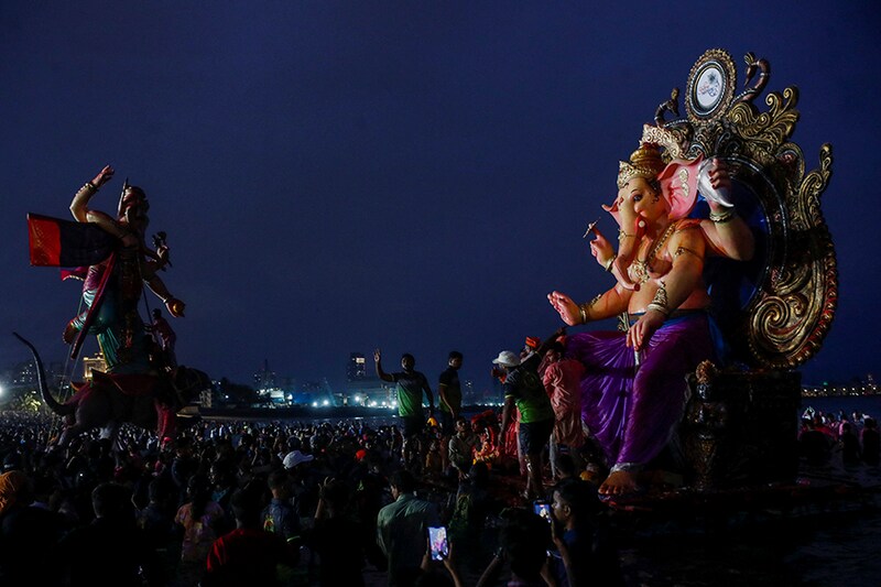 People carry an idol of Lord Ganesh, the deity of prosperity, for immersion into the Arabian Sea on the last day of the Ganesh Chaturthi Festival in Mumbai, India, September 9, 2022.