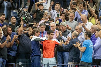 Carlos Alcaraz of Spain is congratulated by coach Juan Carlos Ferrero and his team after his victory against Casper Rudd of Norway in the Men"s Singles Final match on Arthur Ashe Stadium during the US Open Tennis Championship 2022 at the USTA National Tennis Centre on September 11th 2022 in Flushing, Queens, New York City.