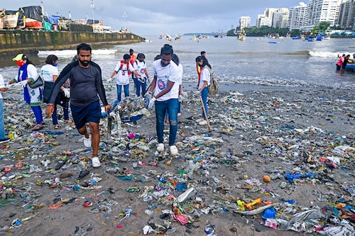 Volunteers collect trash litters during a beach clean-up campaign along the coast of Arabian Sea as part of the "International Coastal Clean-up Day" in Mumbai on September 17, 2022.