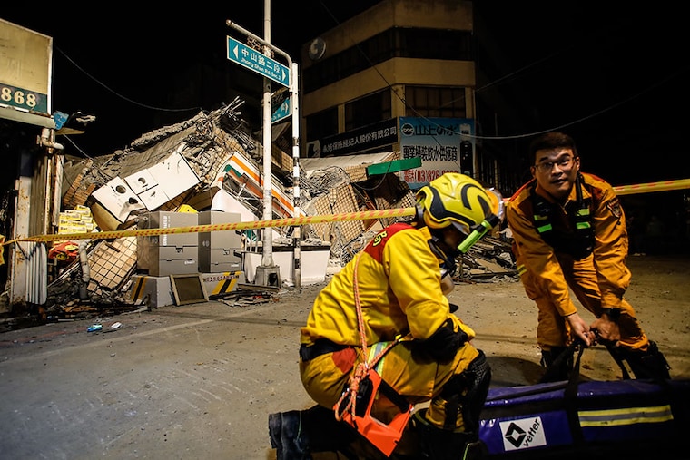Rescuers organising equipment outside the wreckage of a collapsed residential building after a 6.8 magnitude earthquake struck Taiwan, in Yuli, on September 18, 2022. The island has been struck by multiple earthquakes in the past 24 hours, causing buildings to collapse, trains to derail, and destruction of infrastructure.