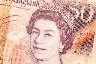 British currency is displayed for a photograph in London on Thursday, Sept. 15, 2022. Queen Elizabeth II’s image is ubiquitous. But before long, the visage of King Charles III will replace his mother’s in official and unofficial capacities. (Alexander Coggin/The New York Times)