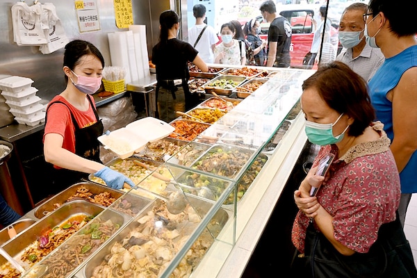 This photo taken on September 18, 2022, shows customers being served low-priced two-dish mealboxes at Kitty Chan"s restaurant in Hong Kong. Image:&nbspPeter Parks/AFP&nbsp