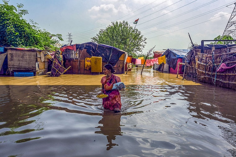 Residents living along the bank of the Yamuna river relocated to higher grounds as the water level started to flow above the danger level on September 27, 2022, in New Delhi, India. Water levels in the Yamuna on Tuesday shot past the evacuation mark of 206m, said the Delhi government, prompting authorities to move thousands of people who live along the river"s floodplains to safe places. The river is expected to swell further on Wednesday, added officials.