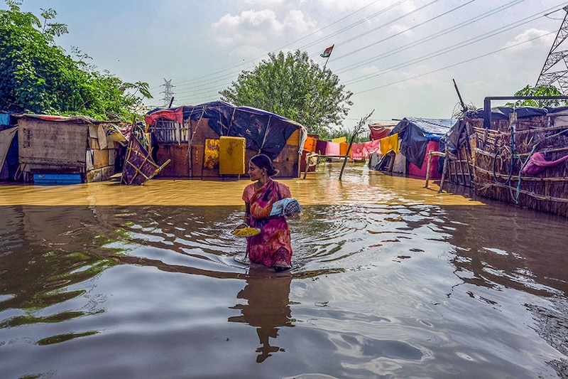 Residents living along the bank of the Yamuna river relocated to higher grounds as the water level started to flow above the danger level on September 27, 2022, in New Delhi, India. Water levels in the Yamuna on Tuesday shot past the evacuation mark of 206m, said the Delhi government, prompting authorities to move thousands of people who live along the river"s floodplains to safe places. The river is expected to swell further on Wednesday, added officials.