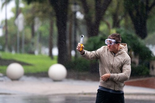 SARASOTA, FL - SEPTEMBER 28: Jacob Woods, a meteorology student at the Mississippi State University, measures wind gusts as Hurricane Ian approaches on September 28, 2022 in Sarasota, Florida. By early afternoon his team observed gusts in excess of fifty miles per hour. Ian is hitting the area as a Category 4 hurricane.