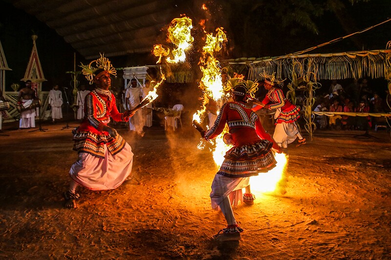 Sri Lankan traditional dancers perform during a traditional Gam-Maduwa or village hut ceremony in Colombo, Sri Lanka, on March 31, 2023. The Gam-Maduwa ceremony is a ritual that invokes the blessings of the goddess Pattini. Image: Pradeep Dambarage/NurPhoto via Getty Images