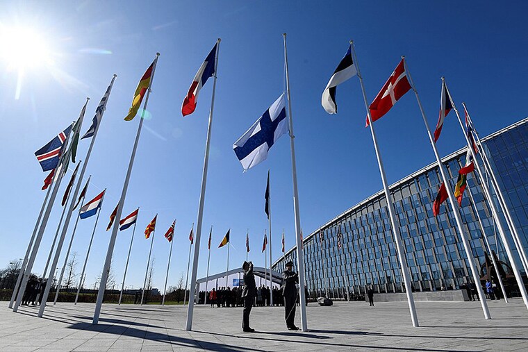 Finnish military personnel install the Finnish national flag at the NATO headquarters in Brussels, on April 4, 2023. Finland became the 31st member of NATO, a historic strategic shift to protect its interests spurred by war in Ukraine, as it shares a 1335 km border with Russia.