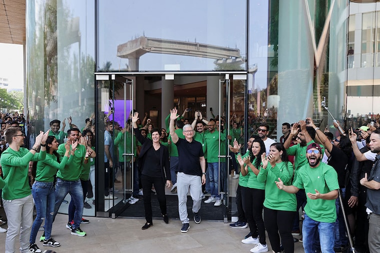 Apple Store staff cheer as CEO Tim Cook and Deirdre O"Brien, Apple"s senior vice president of Retail and People, greet a crowd gathered at the inauguration of India"s first Apple retail store in Mumbai, India, April 18, 2023.