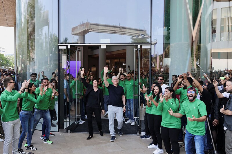 Apple Store staff cheer as CEO Tim Cook and Deirdre O"Brien, Apple"s senior vice president of Retail and People, greet a crowd gathered at the inauguration of India"s first Apple retail store in Mumbai, India, April 18, 2023.