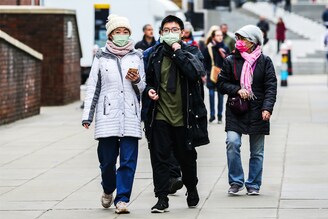 A family is seen wearing face masks in central London. A new Covid-19 strain which has increased infections in India has sparked fears it could also lead to a rise in cases in the UK.