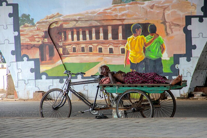 A rickshaw puller takes a break from the sun in the daily market area in the capital city of Bhubaneswar in Odisha on April 27, 2023. The Indian Meteorological Department has issued a yellow alert in the state for the next five days.