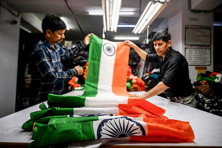 Artisans are making Indian tricolour in a factory in Noida Sector 6 on August 8, 2023. Garment factories in Gautam Budh Nagar of Noida have been busy manufacturing large quantities of the Indian national flag at Noida Apparel Export Cluster (NAEC) to fulfil demand due to the "Har Ghar Tiranga" initiative.