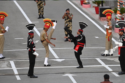 Pakistani Rangers (in black) and Indian Border Security Force (BSF) soldiers take part in the "Beating the Retreat" ceremony on the eve of Pakistan"s Independence Day celebrations at the India-Pakistan Wagah border post, about 30km from Amritsar, Punjab on August 13, 2023.