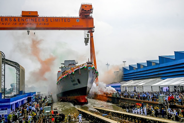 Employees of Garden Reach Shipbuilders and Engineers (GRSE) celebrate as President Droupadi Murmu (not pictured) launches the INS Vindhyagiri, the last in the series of three P17 frigates for the Indian Navy at the GRSE dock in Kolkata on August 17, 2023.