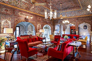 The magnificent living room of Samode Haveli, where the walls are adorned from floor to ceiling with hand-painted frescoes, dating back to the illustrious 18th century