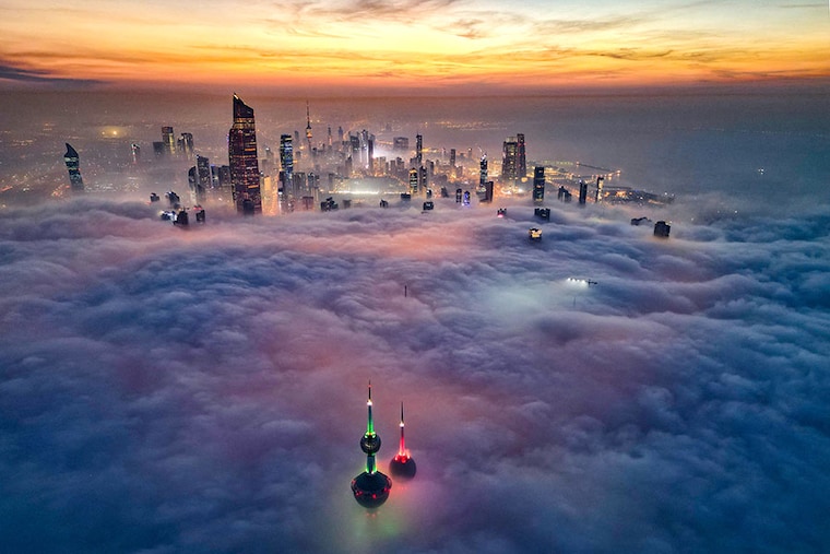 In this aerial view, the landmark Kuwait Towers and other skyscrapers pierce through the cloud cover over Kuwait City on December 10, 2023.