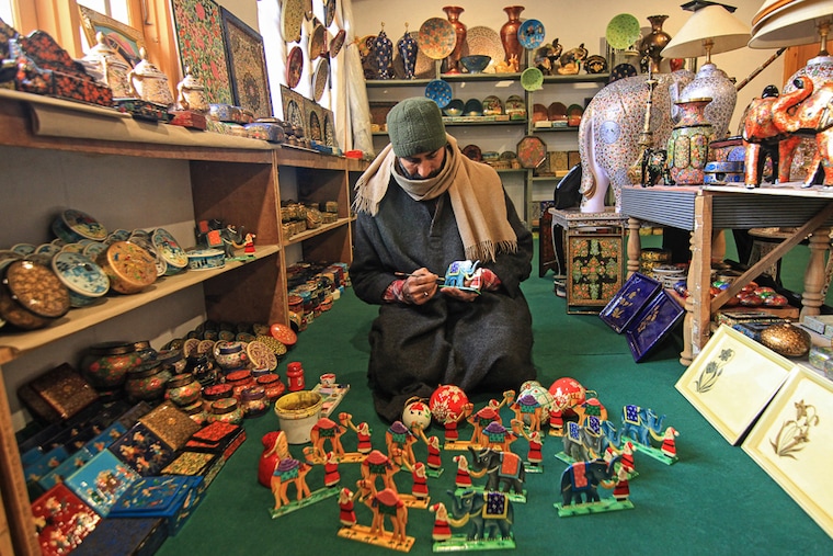 A Kashmiri artisan hand crafts a papier-mache Christmas gift item at his workshop in Srinagar, Kashmir, on December 16, 2023. These Christmas gift items made of papier-mache are being sent to local markets and also exported to the US, Italy, Germany, France, Canada, Australia, Hong Kong, and many other parts of the world ahead of Christmas celebrations. Image: Faisal Khan/NurPhoto via Getty Images