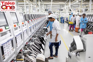 Employees work on an assembly line in the mobile phone plant of Rising Stars Mobile India Pvt., a unit of Foxconn Technology Co. in Sriperumbudur, Tamil Nadu. Image: Karen Dias/Bloomberg via Getty Images