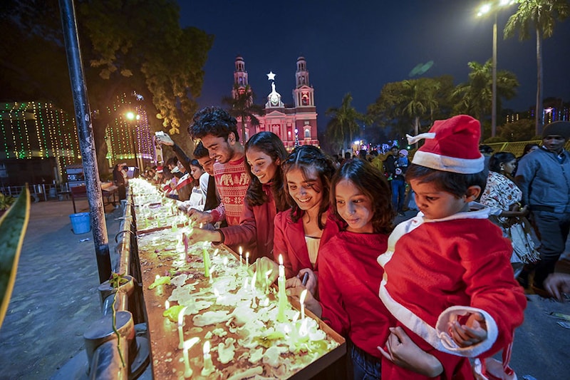 Devotees light candles at the Sacred Heart Cathedral Church during Christmas Day celebrations on December 25, 2023, in New Delhi, India.