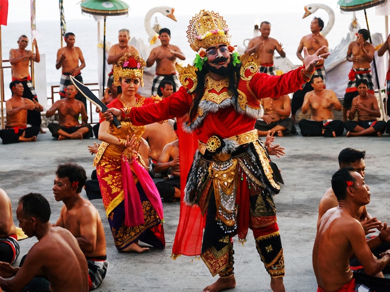 In this picture taken on December 28, 2023, dancers and actors perform in the à¬Titi Situbandaà® Kecak dance theatre at Melasti Beach near Ungasan in Bali, Indonesia. Kecak is a Balinese dance drama that presents the story of Hindu puppetry, especially the Ramayana story. Image: David Gannon/AFP