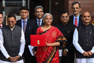 India"s Finance minister Nirmala Sitharaman poses for a photograph as she leaves the Finance ministry to present the annual budget in the parliament in New Delhi on February 1, 2023.