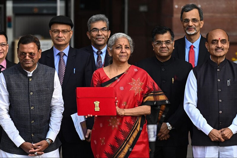 India"s Finance minister Nirmala Sitharaman poses for a photograph as she leaves the Finance ministry to present the annual budget in the parliament in New Delhi on February 1, 2023.